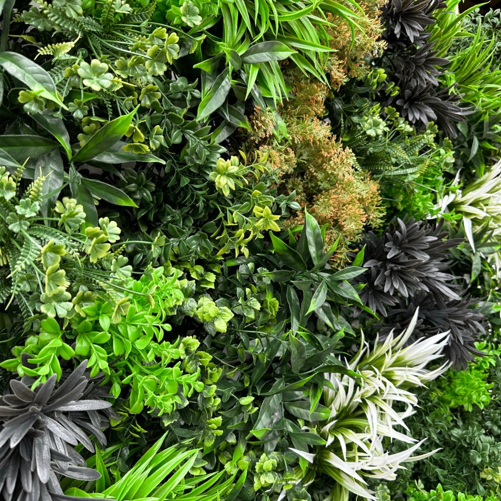 Artificial foliage wall panel closeup with mixed green tones, dark gray and white