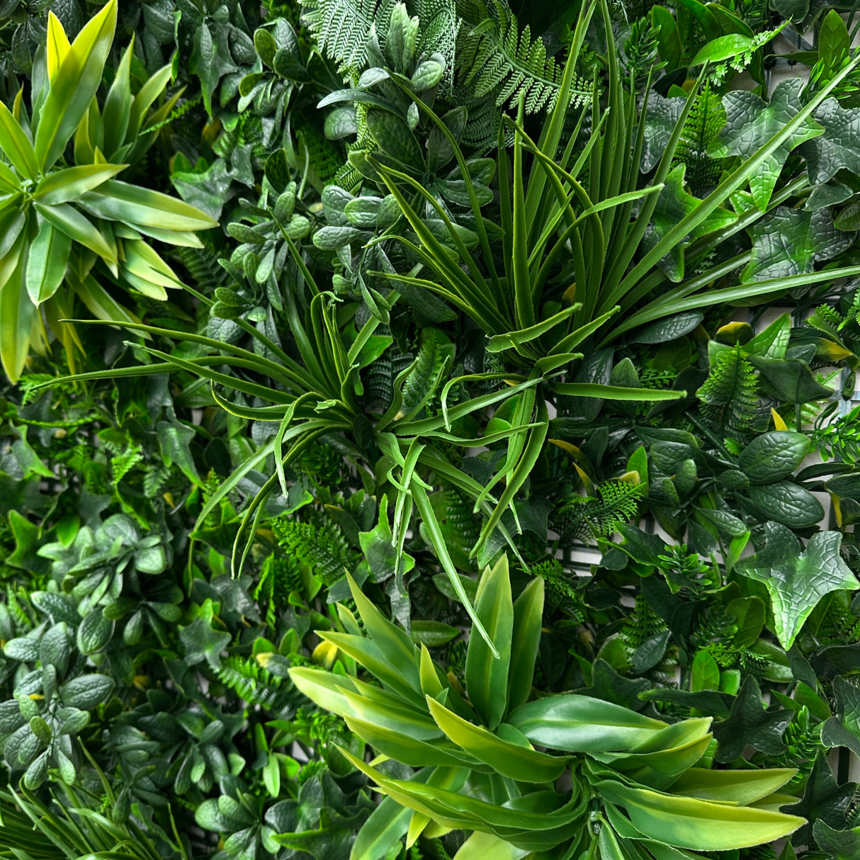 Artificial green wall panel with variegated foliage ivy palms grasses and ferns 100x100 cm