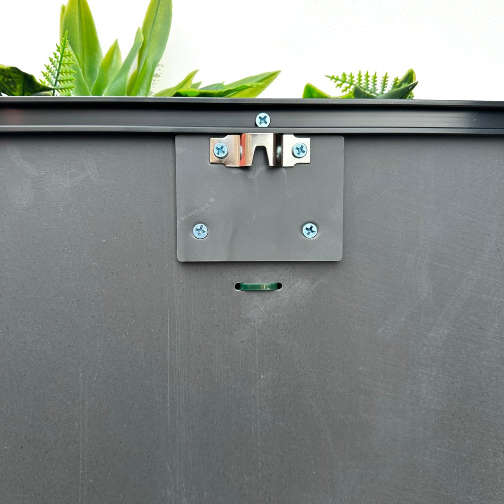 Artificial foliage wall art panel mounting hardware on dark gray backing