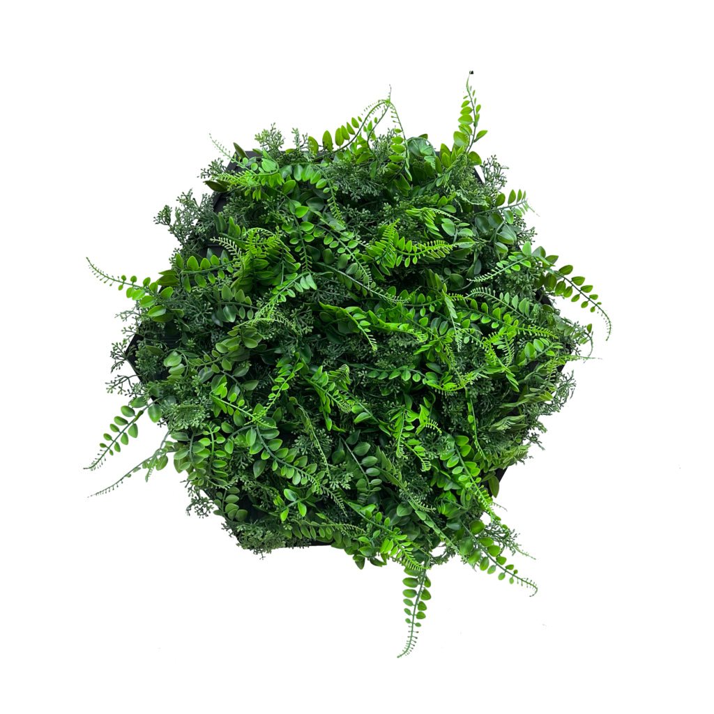 Artificial green foliage panel in black hexagonal aluminum frame, dense leaf texture.