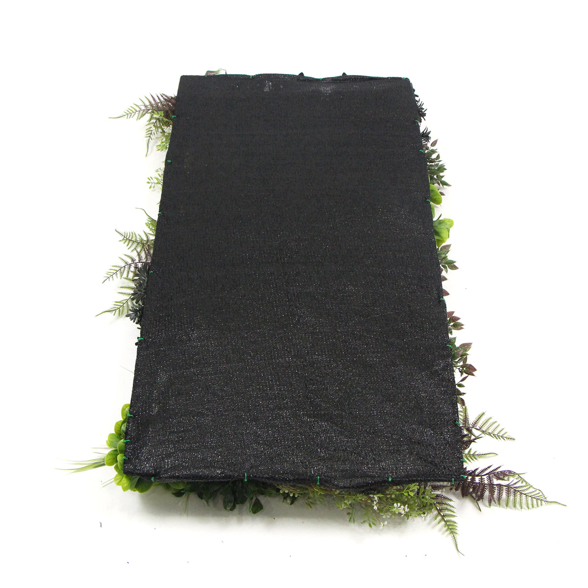 Artificial plant wall panel with black backing mat and faux greenery along the edges