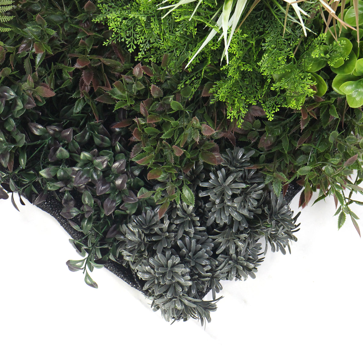Artificial plant wall panel close-up of dark green and gray faux leaves with small clusters