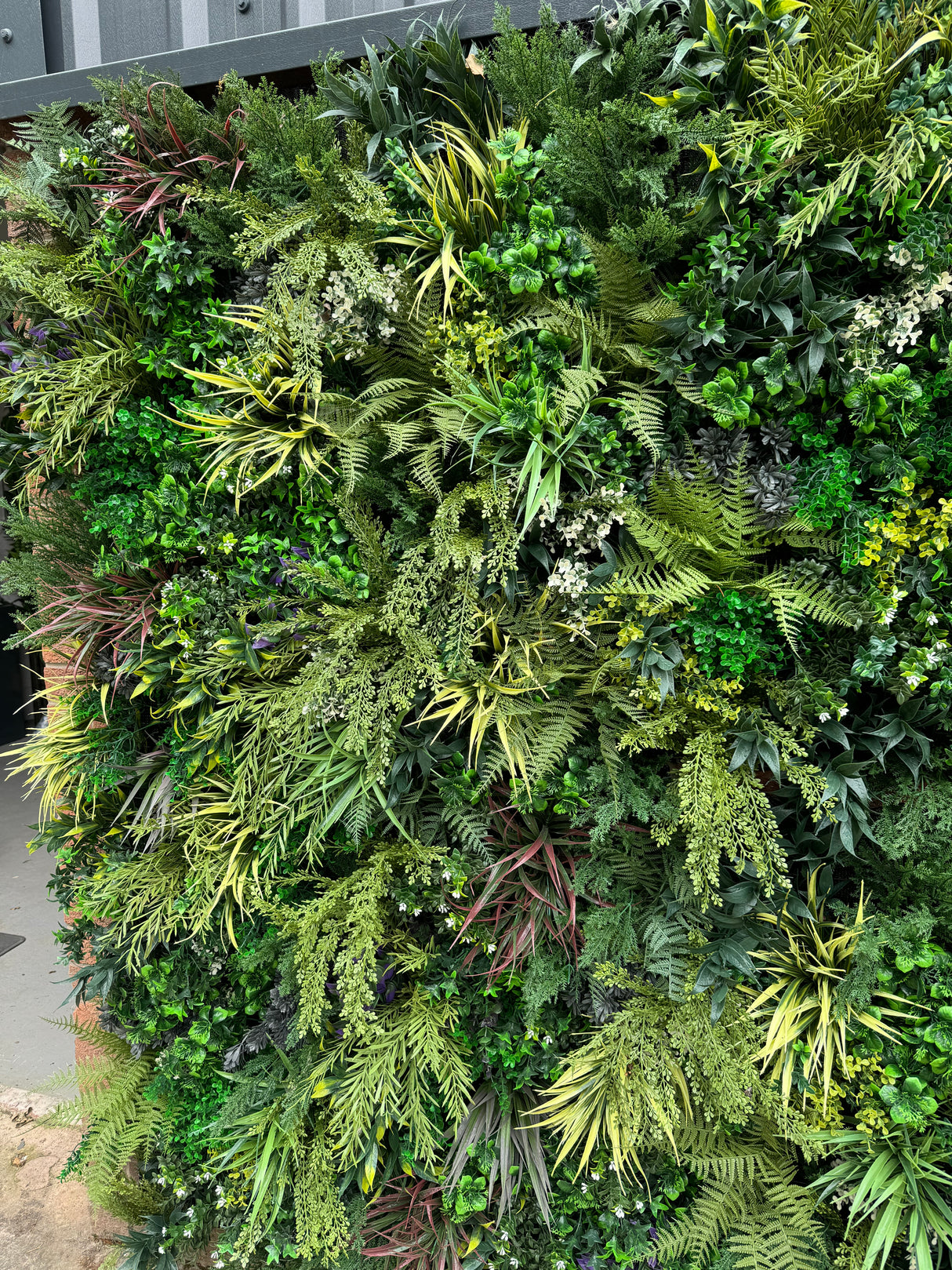 Ultra Realistic Artificial 3D plant wall PW25 with lush dark and light green foliage, yellows  and whites 100x50cm