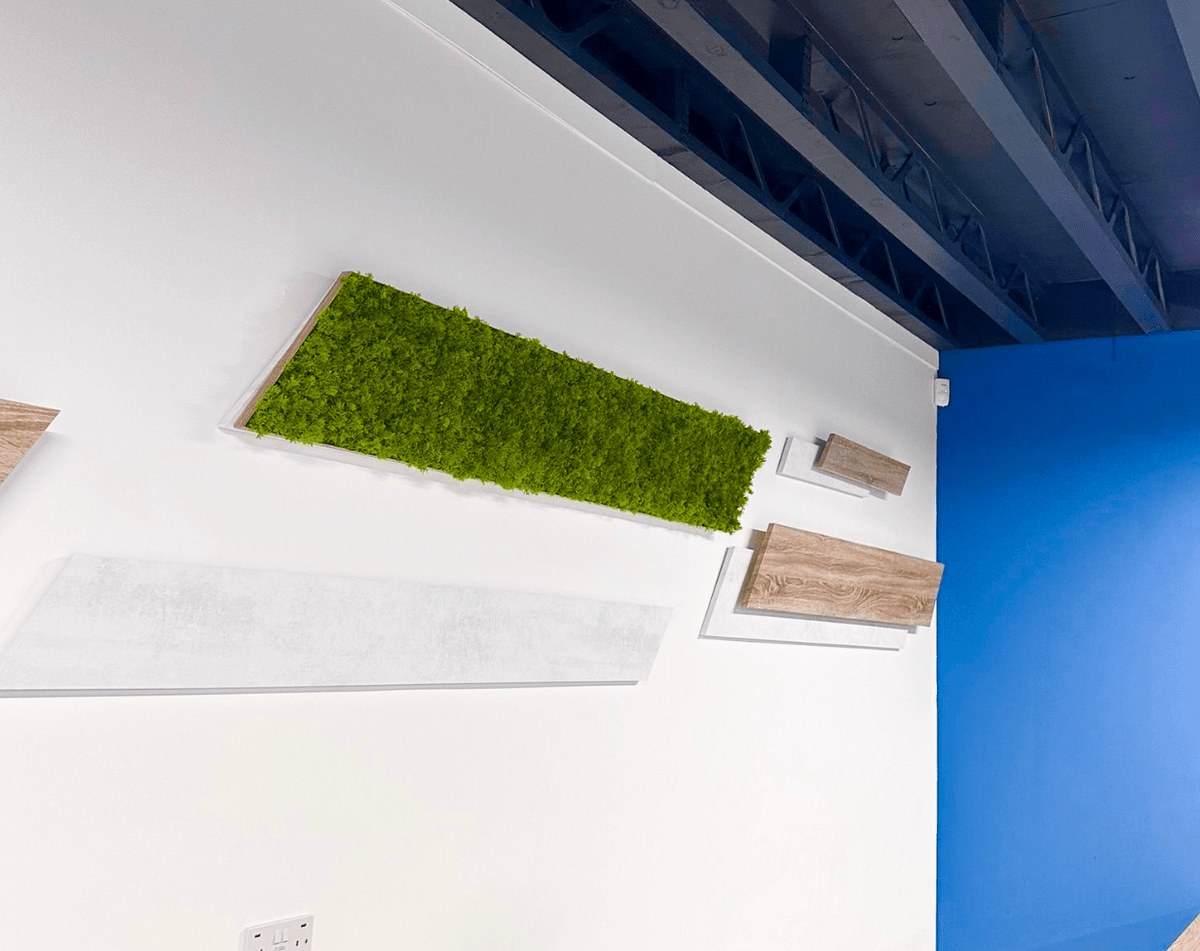 Artificial moss panel strip in a rectangular ceiling inset, bright green textured surface