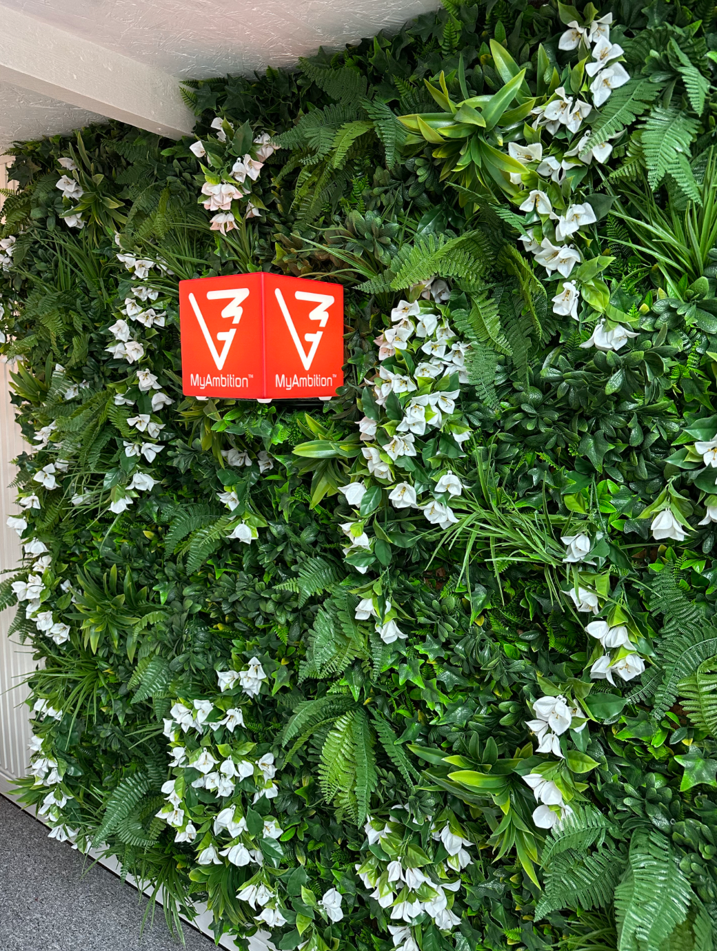 Artificial foliage wall panel with white flowers and variegated green leaves, MyAmbition tag