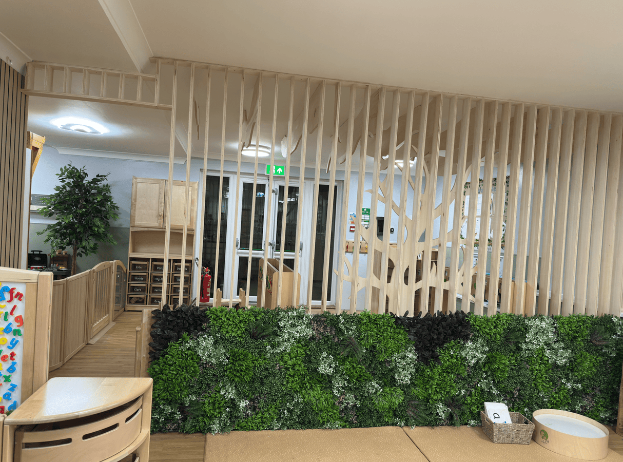 Artificial interior wall panel with mixed green foliage, burgundy tones, and white tips