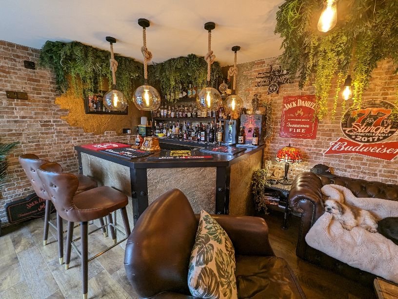Artificial hanging green foliage backdrop with dense trailing leaves behind a counter