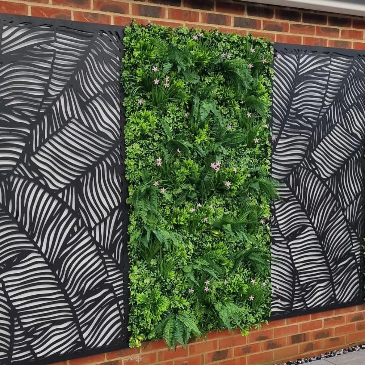 Artificial green wall panel with mixed 3d light-dark green foliage with scheffleras & pink flowers 100x100 cm