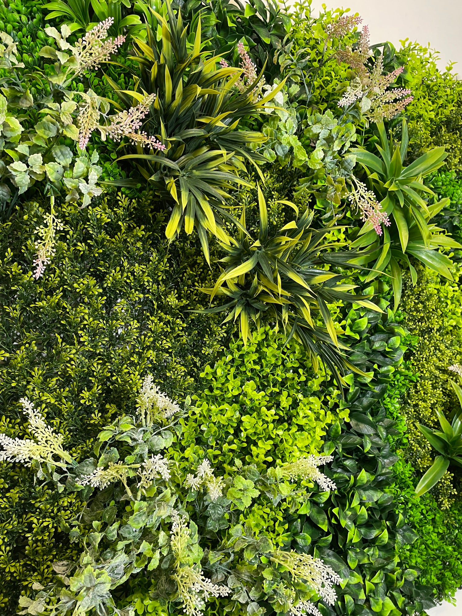 Artificial green wall panel varigated  green foliage  palms heads and white purple-pink flowering heads 100x100 cm