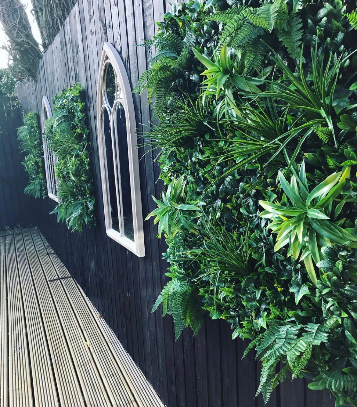Artificial green wall panel with variegated foliage ivy palms grasses and ferns 100x100 cm
