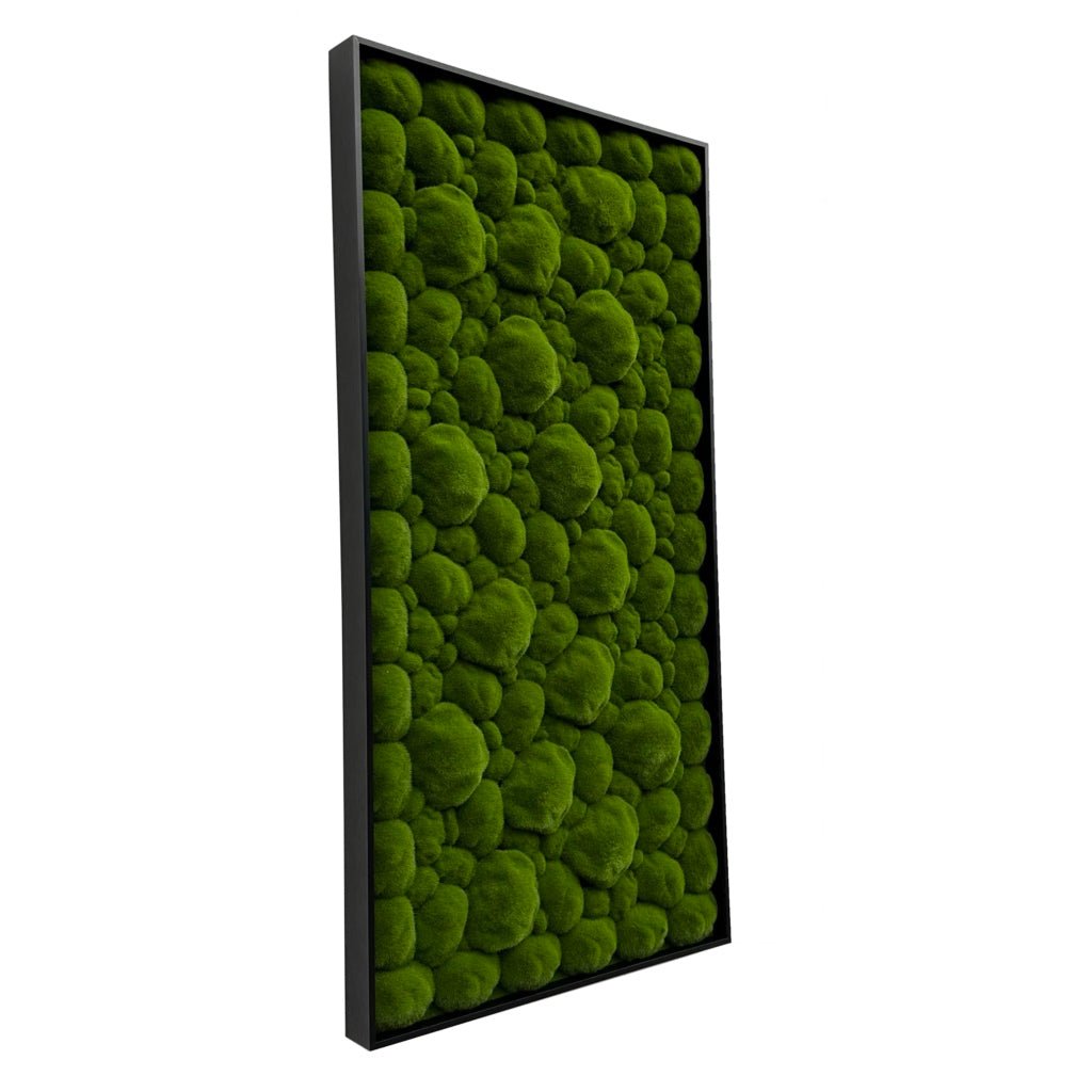 Artificial moss wall art panel with dense green tufts on a black aluminum frame, angled view.