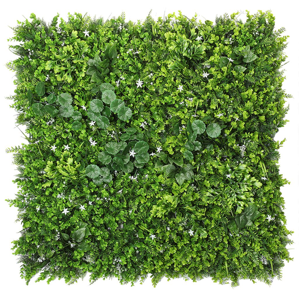 Artificial green plant wall panel featuring dense foliage with small white star flowers