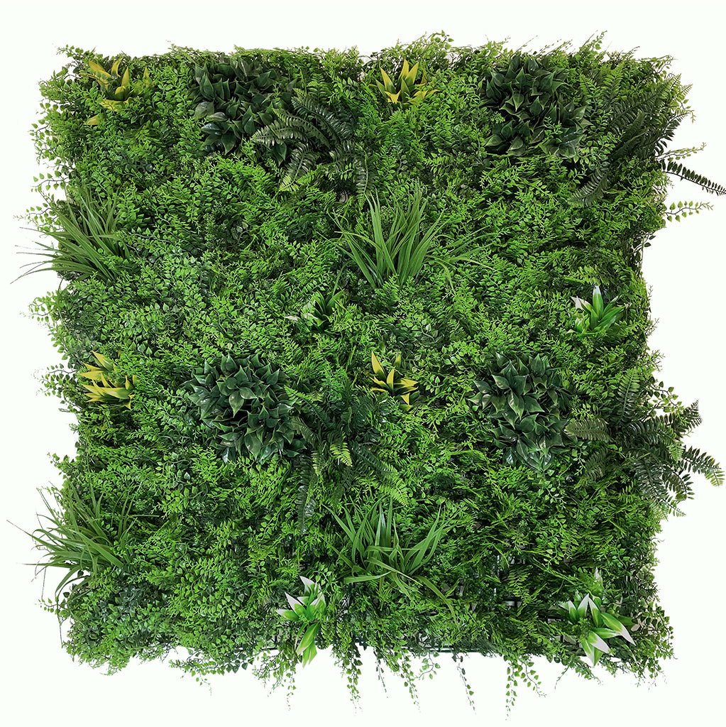 Artificial green wall panel with mixed ferns, grasses, and shrubs in varied greens