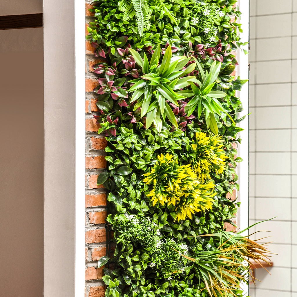 Artificial green foliage wall panel with mixed greens, yellow tones, and red-tinged leaves