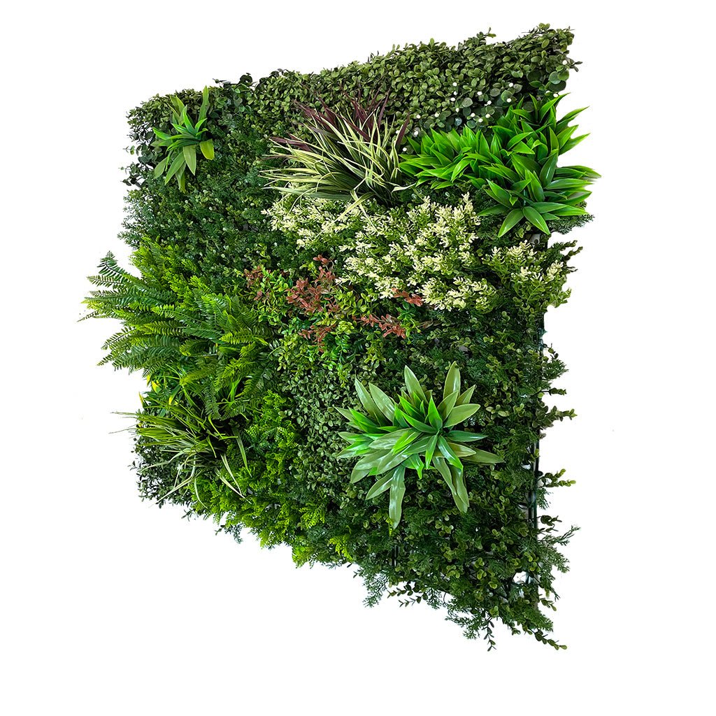 Artificial green foliage wall panel with layered tropical plants in varied greens