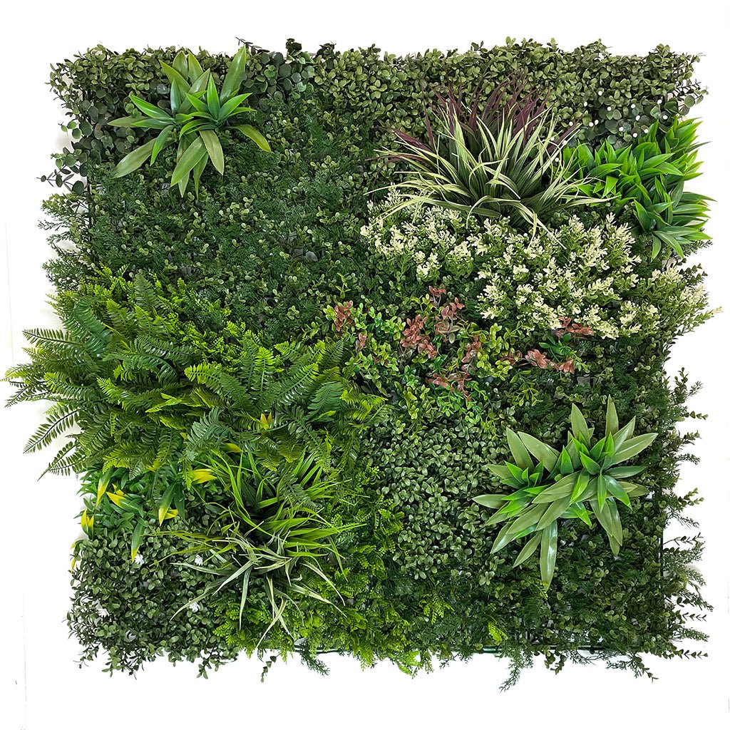 Artificial green foliage wall panel with dense shrubs, ferns, and orange-white accents
