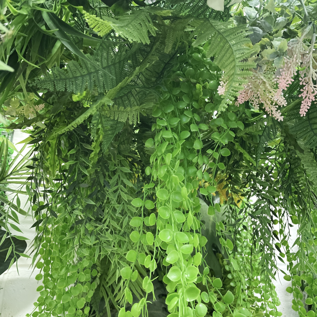 Hanging hoop with a mixture of artificial green plants with yellow flowers 80cm diameter