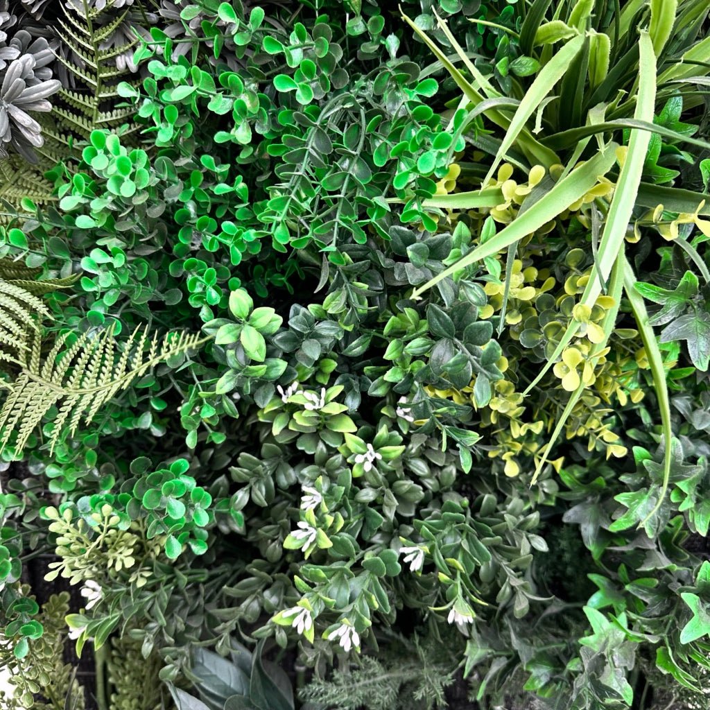 Artificial 3D plant wall panel close-up with mixed dark and light green leaves