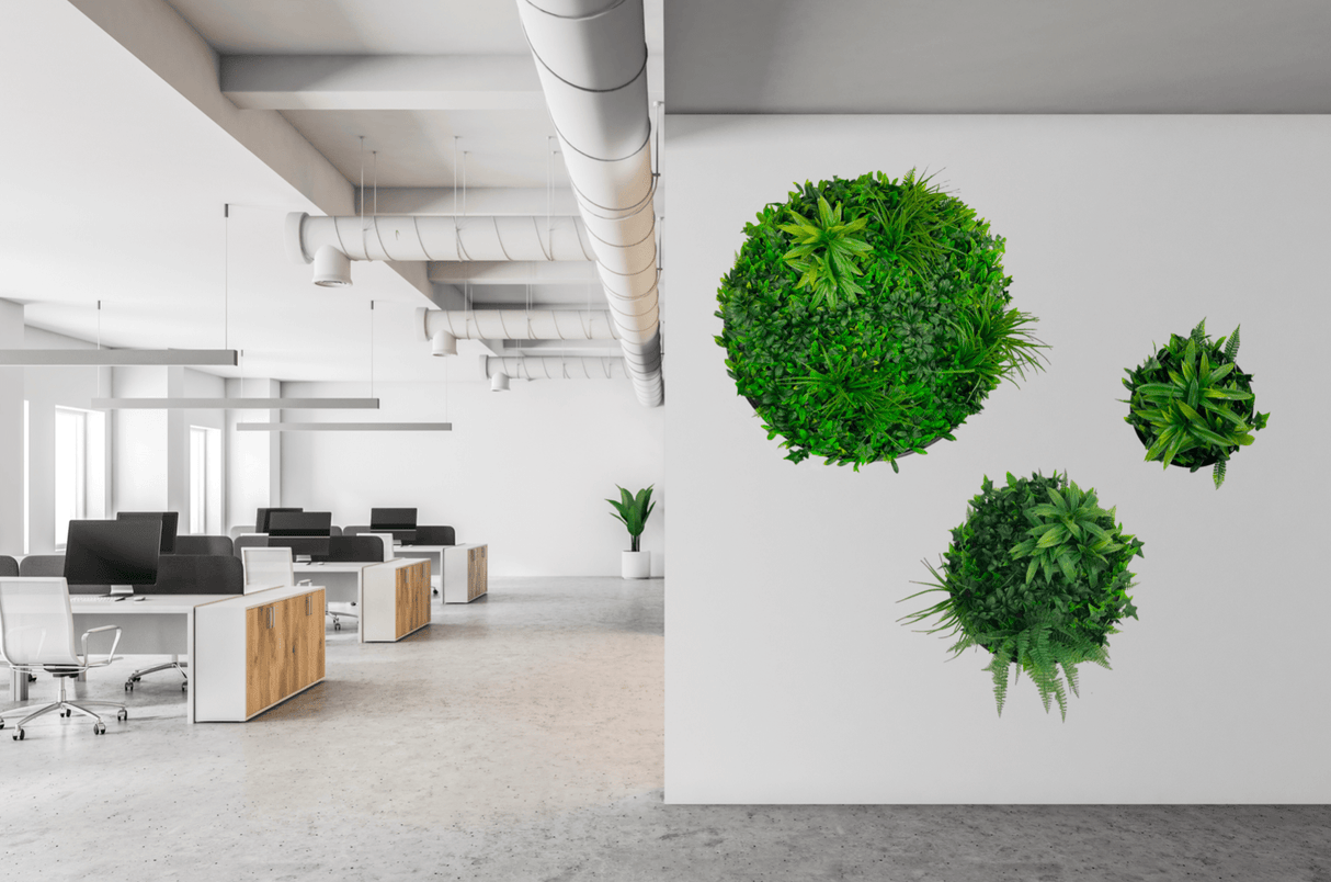 Green artificial foliage circular wall art panel on office wall
