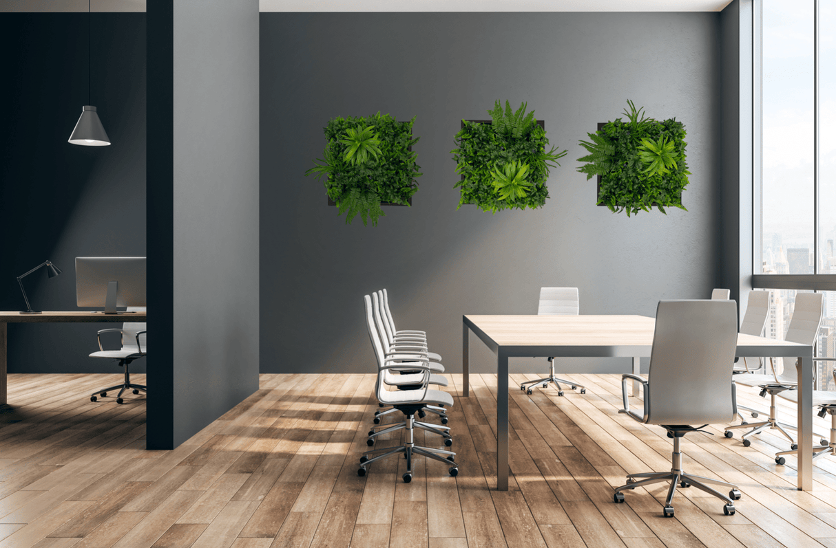 Artificial green foliage wall art panel with black frame and three plant clusters