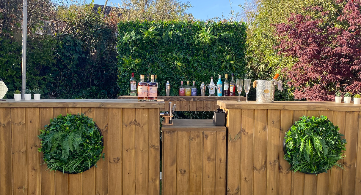 Artificial green foliage circular wall panels on a wooden outdoor fence