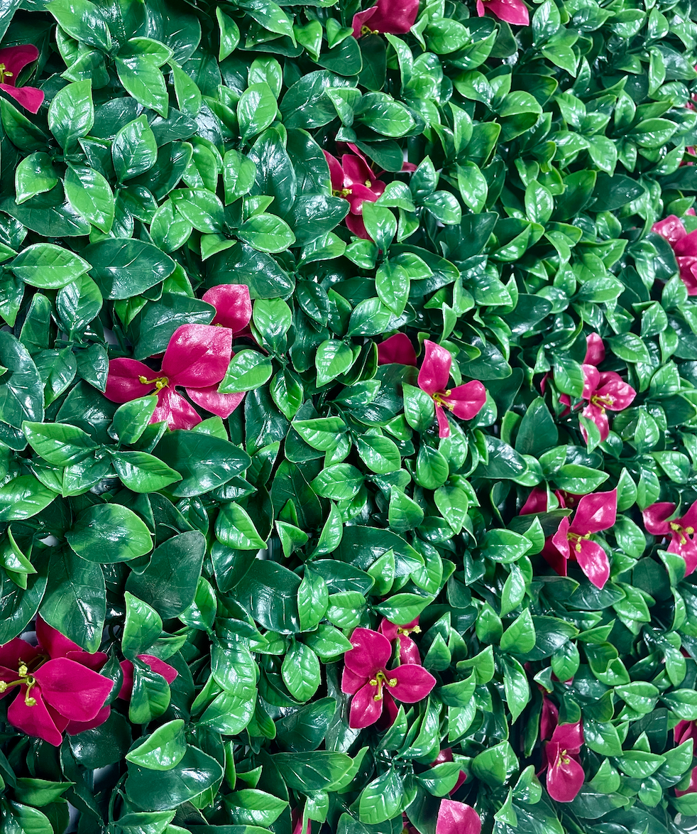 Artificial wall foliage panel with shiny green leaves and scattered pink blossoms