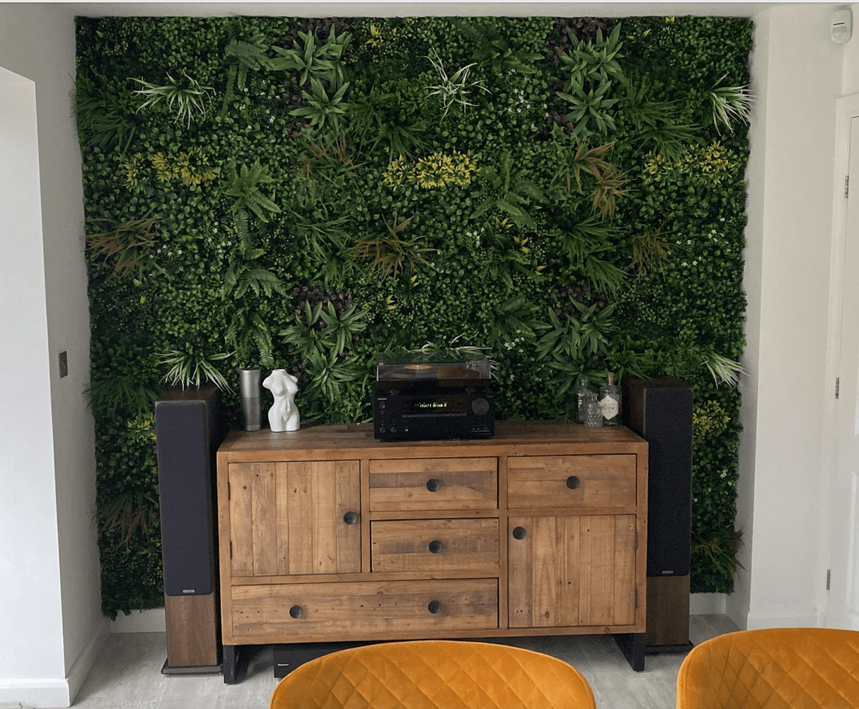 Indoor artificial greenery wall panel with dense foliage covering a full wall section
