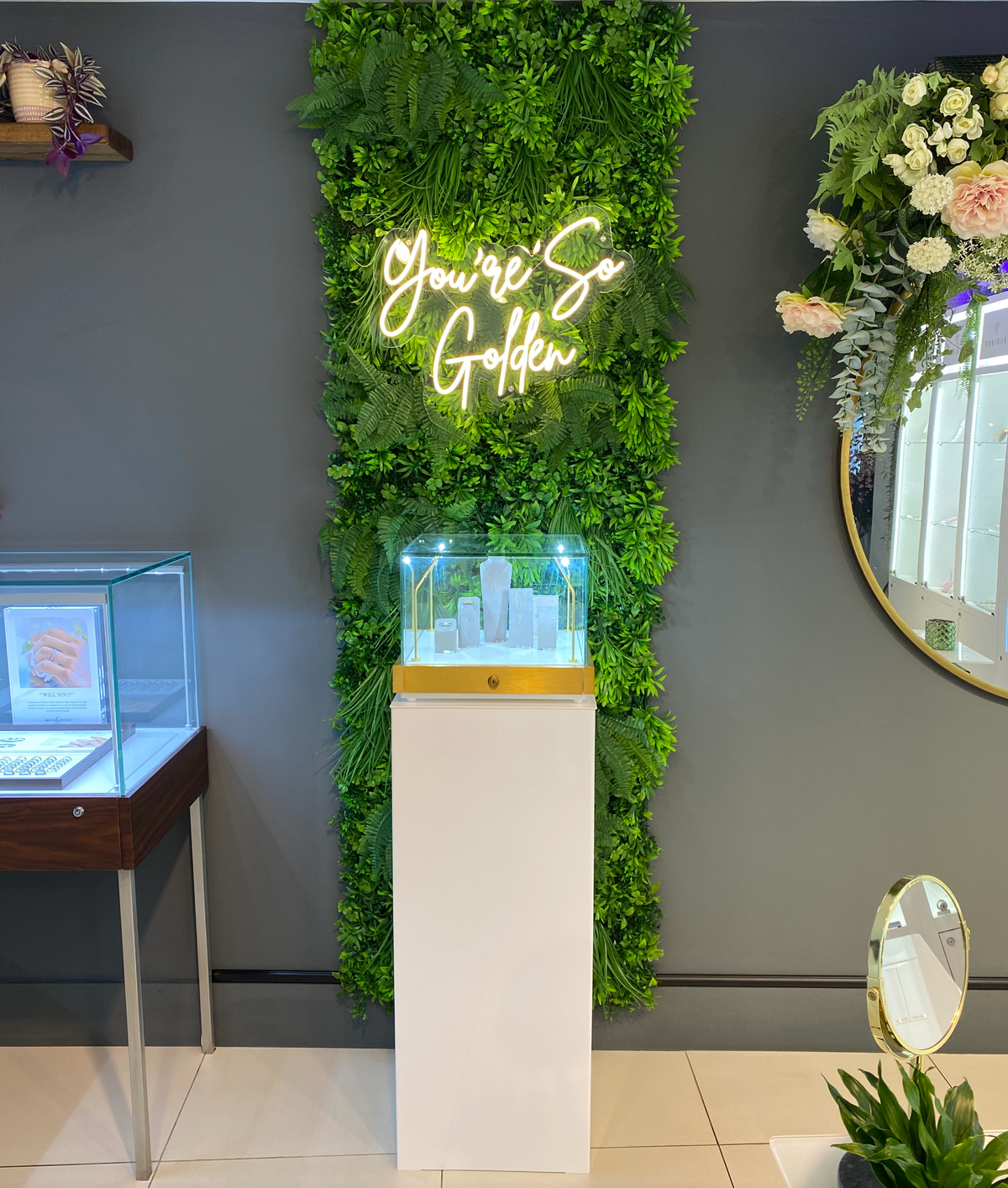Artificial foliage wall panel with green leaves and 'You're So Golden' text