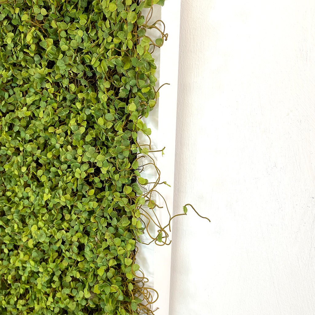 Artificial moss foliage panel corner detail with hanging vine-like strands