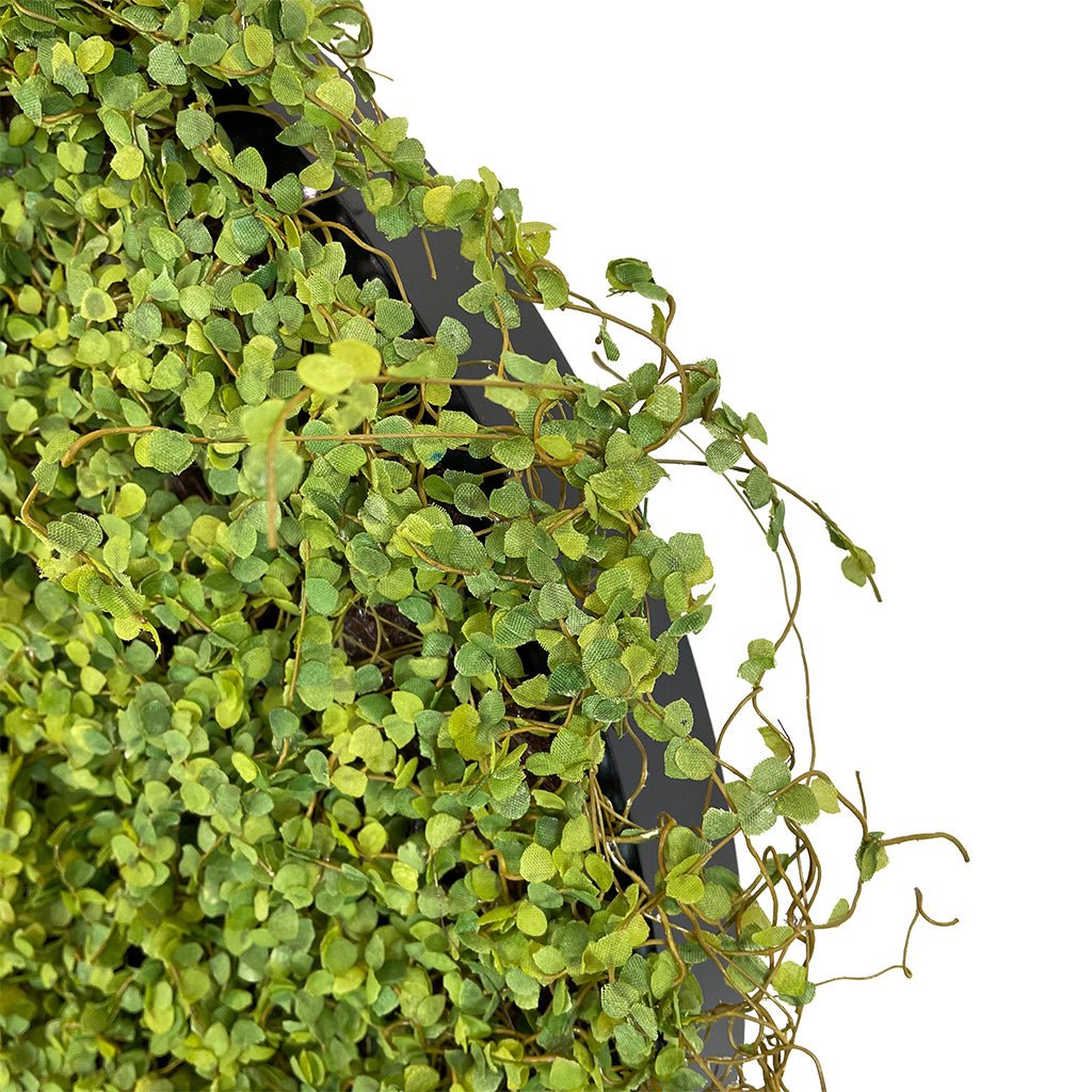 Artificial twig moss wall panel close-up of small green faux leaves and stems