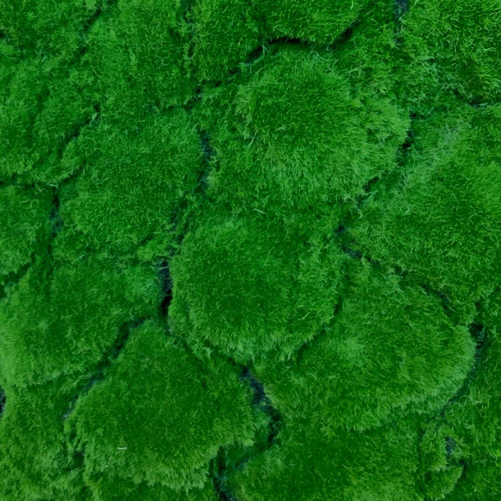 Artificial green moss panel close-up of dense tufted surface with slight gaps