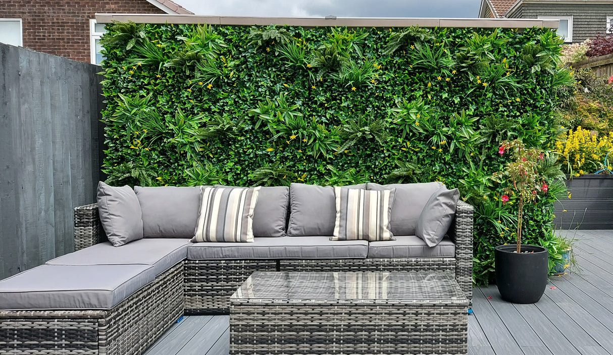 Artificial green wall panel with variegated greens of ivy, ferns, palm heads, grasses & small yellow flowers 100x100 cm