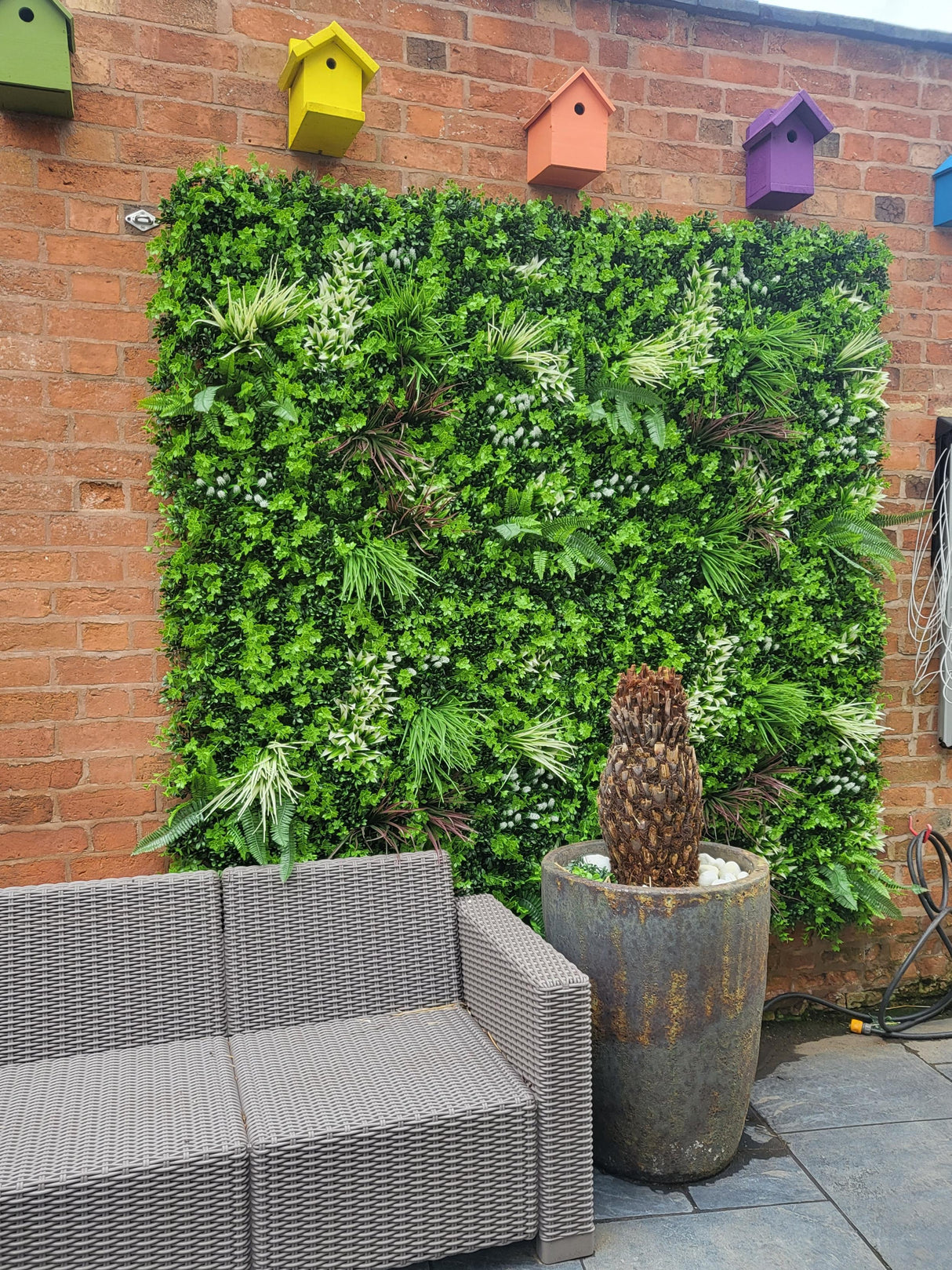 Artificial green wall panel with mixed green orange red and white foliage, white and yellow flowers 100x100 cm