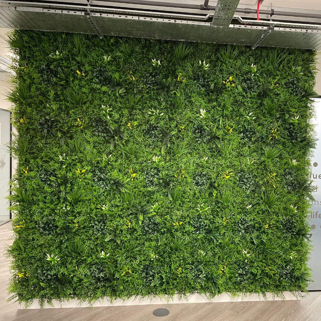 Artificial green wall panel with lush green foliage and mixed leaf textures