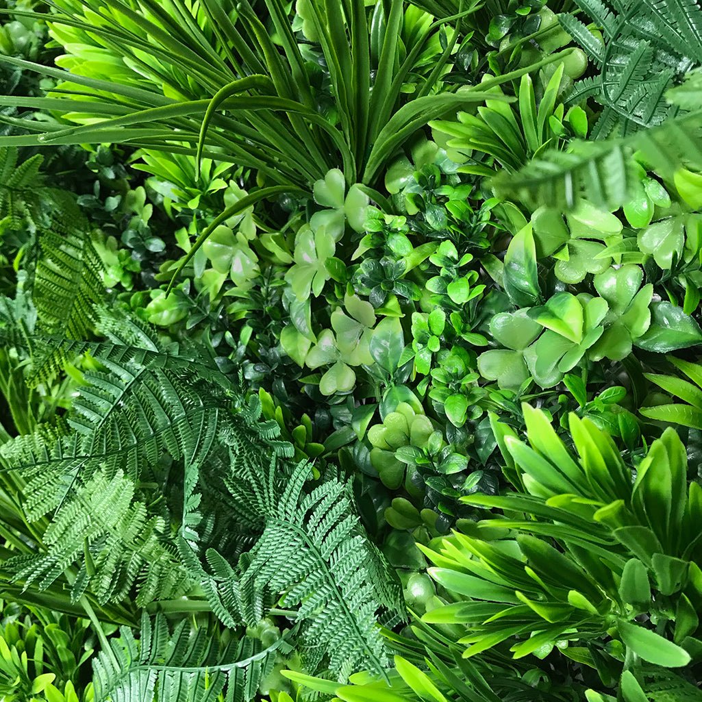 Artificial green foliage wall panel with mixed light-dark leaf texture