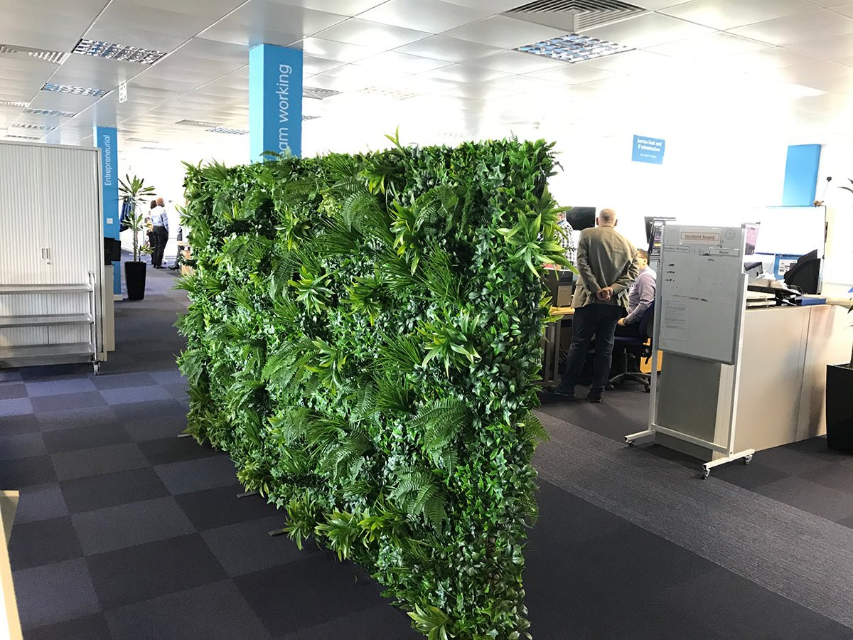 Large artificial green wall panel with layered faux ivy, palms, and ferns for interior decor