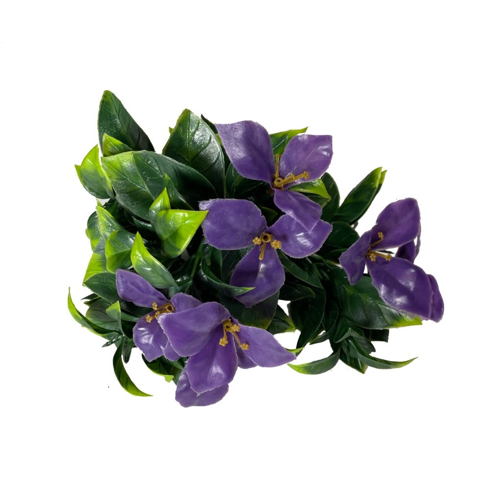 Green floral bundle with purple five-petal blossoms and broad dark leaves