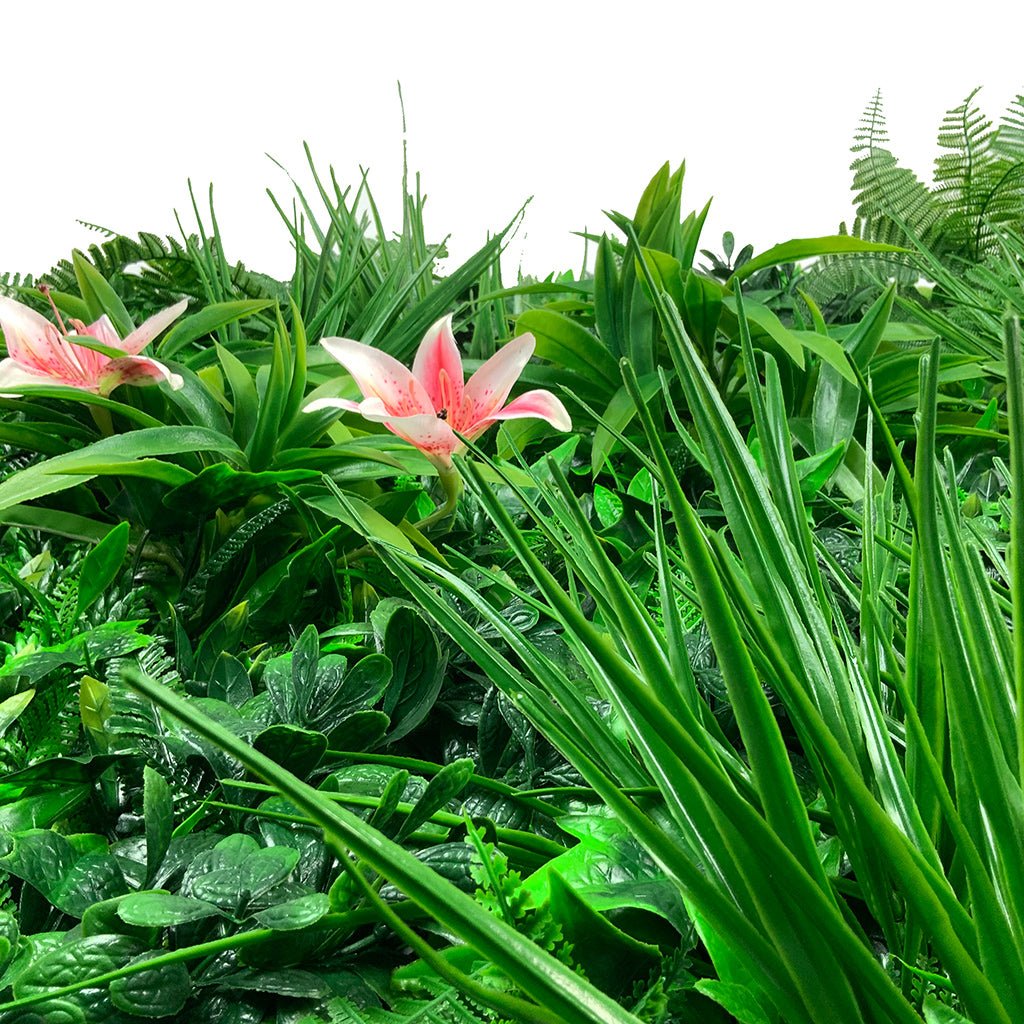 Artificial green foliage wall panel with dense grass-like leaves and small pink lilies