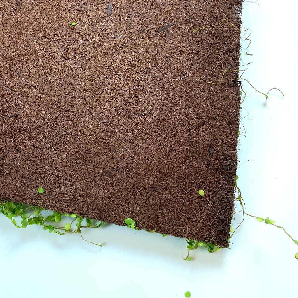 Artificial twig moss panel corner view: brown backing with green moss sprigs