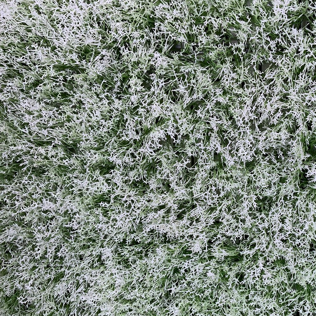 Close-up of artificial moss panel tufts in light and green tones, dense texture.