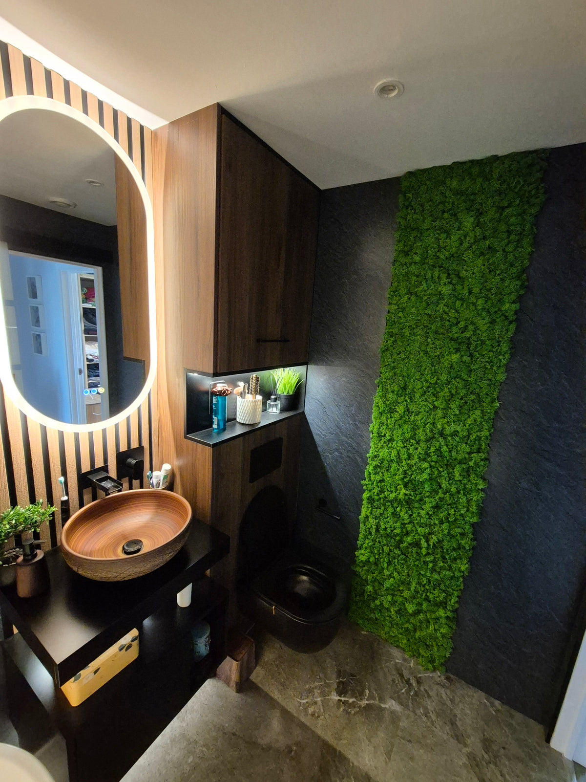 Green reindeer moss wall panel strip on dark wall, dense texture