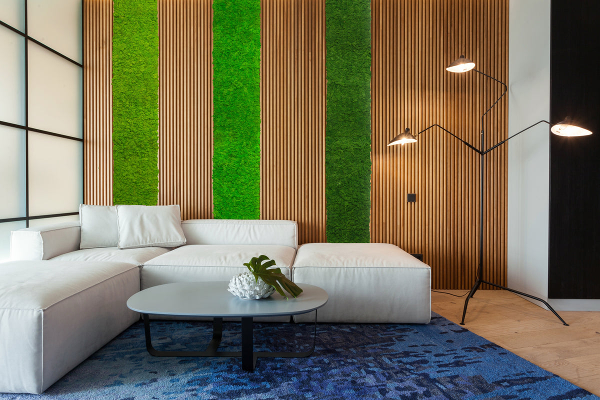 Forest green moss wall panel behind a white sofa in a modern room