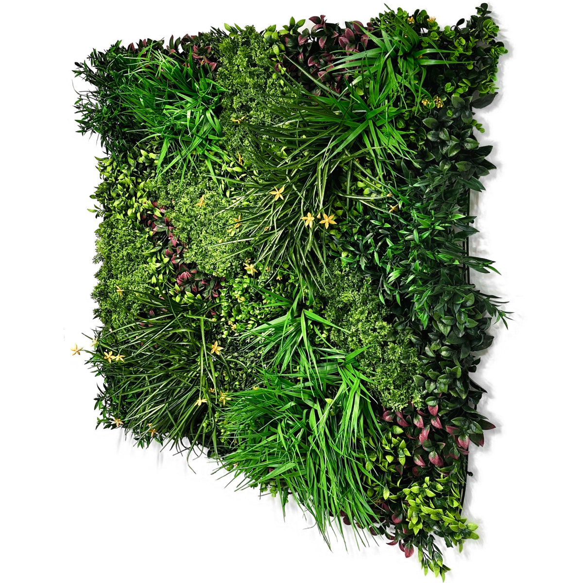 Artificial green foliage wall panel with varied leaf textures and tiny yellow blooms