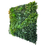 Artificial green wall panel with variegated foliage ivy palms grasses and ferns and orange foliage 