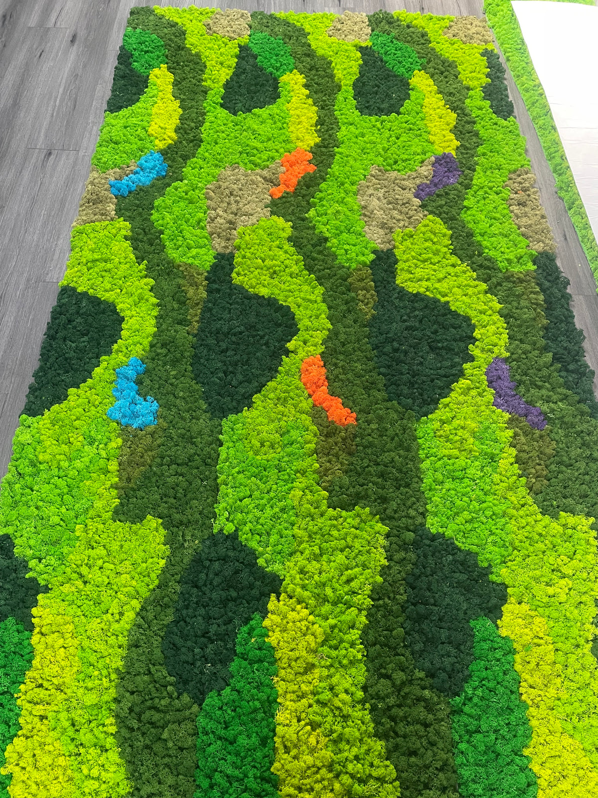 Self-adhesive preserved moss panel, long runner design in bright green with blue, orange, purple details