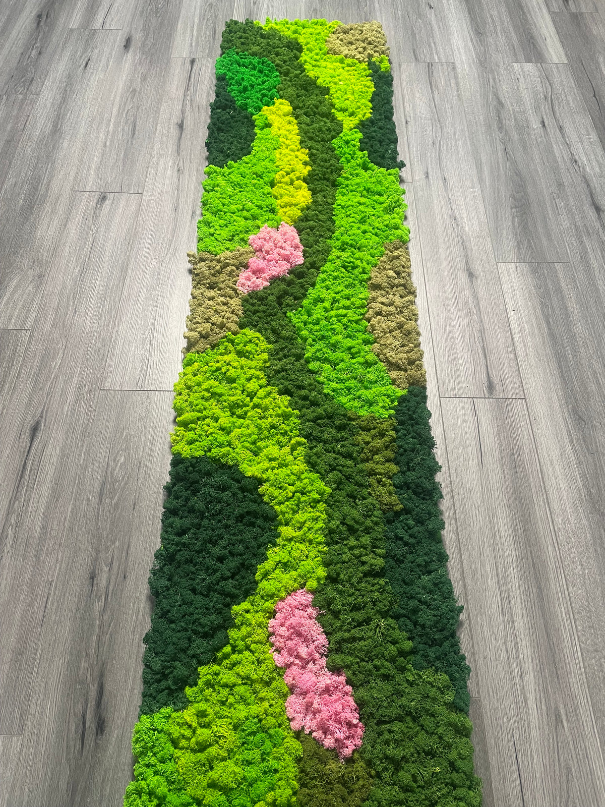 Self-adhesive preserved moss panel runner with bright green waves, dark green sections, and pink clusters