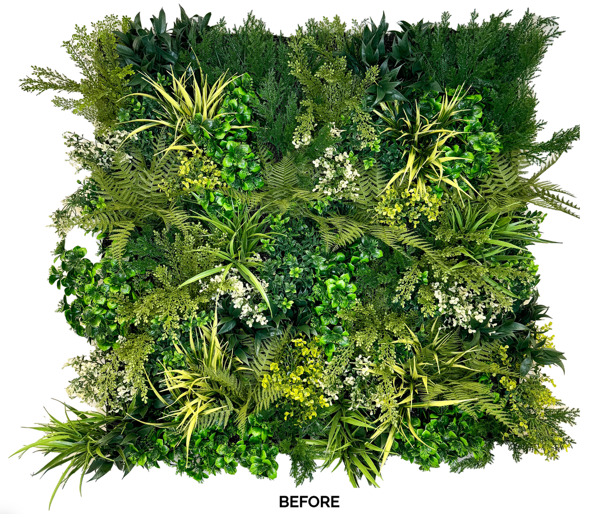 Artificial 3D plant wall panel featuring dense mixed green foliage and small white flowers