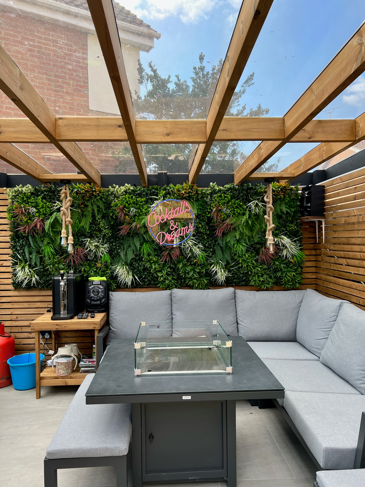Artificial green wall panel with dense mixed foliage and small white flower accents