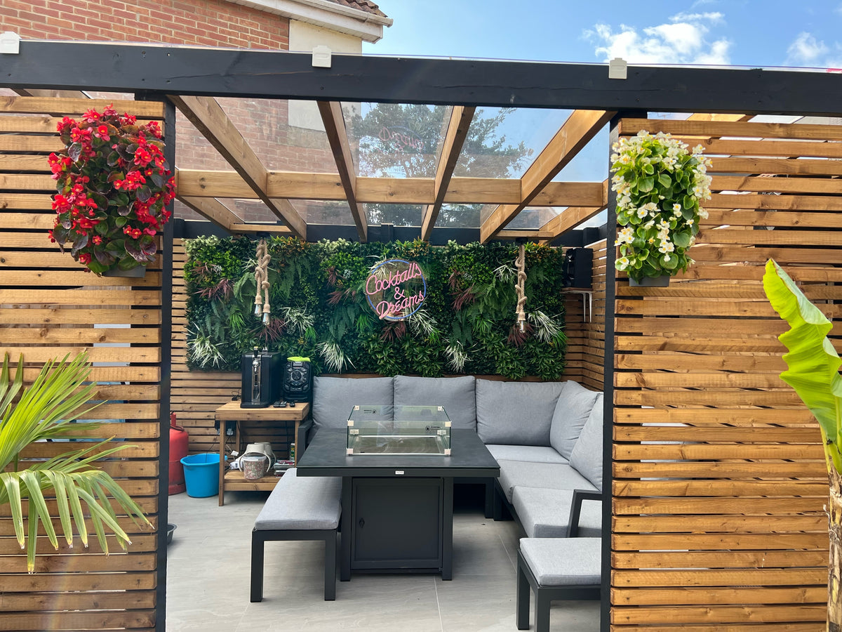 Artificial green wall panel with mixed foliage and red flower accents, plus white blooms