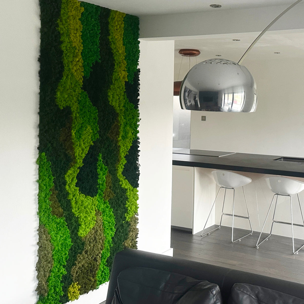 Forest green moss wall panel beside a kitchen counter and bar stools